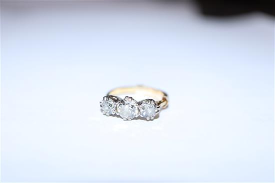 A yellow metal and three stone diamond ring, size H.